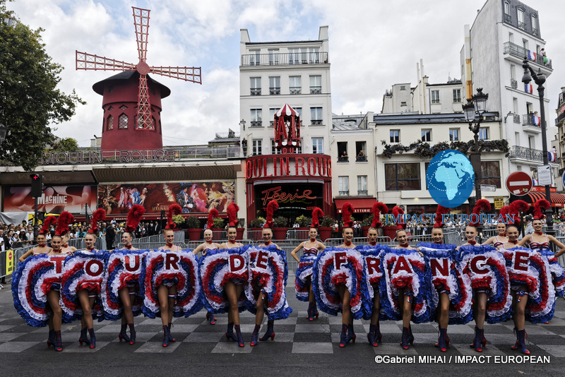 Moulin Rouge dancers form the words "Tour de France" outside the famous Paris cabaret during the race finale.