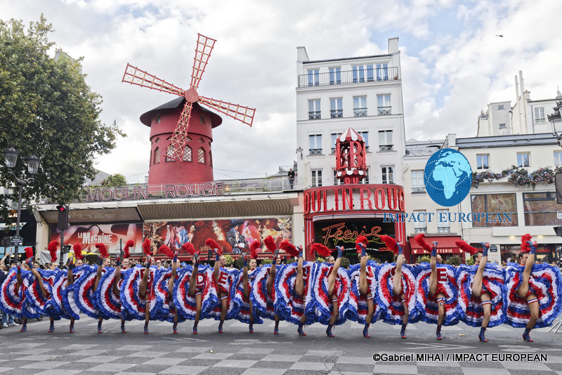 French Cancan dancers perform outside the Moulin Rouge before the arrival of Tour de France riders in Paris.