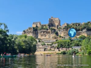 Canoes on the Dordogne below the medieval village and Château de Beynac in France