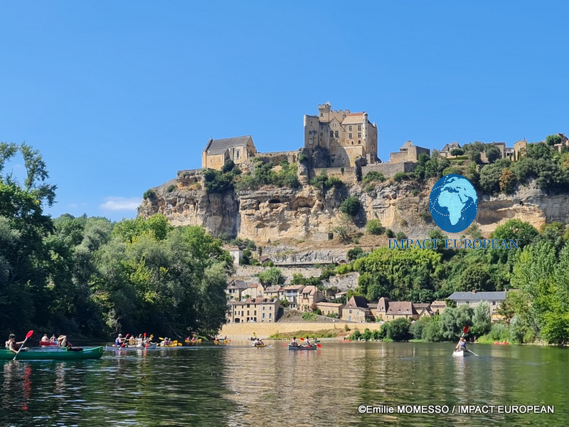 Canoes on the Dordogne below the medieval village and Château de Beynac in France
